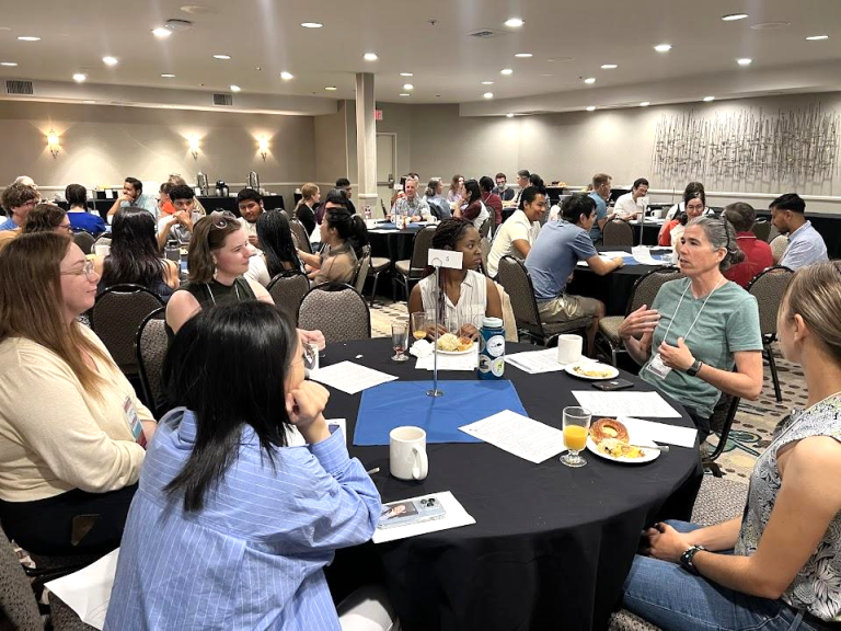 Groups of people sitting at tables at a SCEC workshop